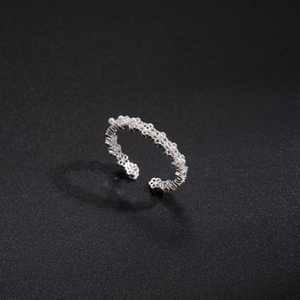 Detail of silver floral镂空 ring with white zircon stones and adjustable band setting