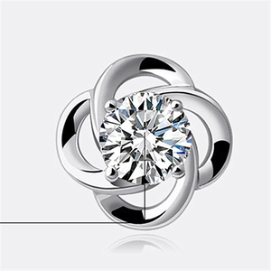 Macro shot of silver stud earring with cubic zirconia in a clover floral design