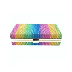 Macro shot of colorful rhinestone rainbow stripes on a rectangle evening clutch bag