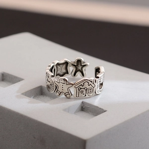 Vintage silver gingerbread man open ring with engraved stars and house patterns