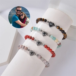 Detail view of heart projection stone bracelets with natural tiger eye and agate beads