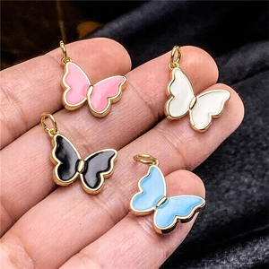 Colorful butterfly enamel charms in pink, white, black and blue with gold finish