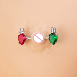 Detail of stainless steel nipple ring with red and green pear-cut crystal charms