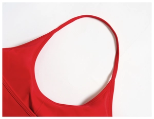 Macro detail of red yoga set showing fine stitching and premium elastic fabric