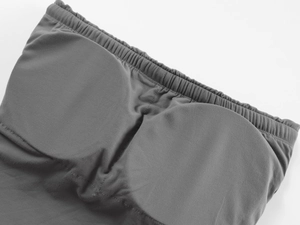 Close-up of seamless gray strapless bra showing built-in pads and elastic high-stretch fabric