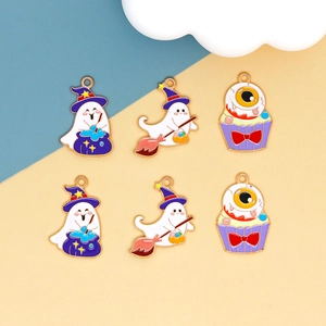 Detailed macro view of colorful Halloween charms featuring ghost, witch hat, and eyeball cupcake