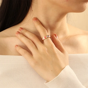 Detailed close-up of a vintage colorful oil drip heart palm ring with gold plating finish