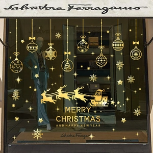 Golden Christmas window stickers featuring Santa sleigh, snowflakes and festive ornaments