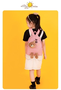 Pink toddler backpack with plush bear and 'very happy' embroidery on a yellow background