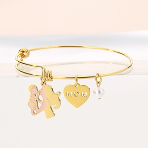 Detail of gold adjustable bracelet with MOM heart, pearl and pink enamel mother-child charm