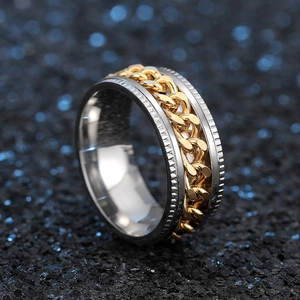 Macro shot of two-tone rotatable chain ring with gear textured edges in punk style