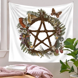 Bohemian witchcraft tapestry detail featuring stars and natural flora in a cozy room setting