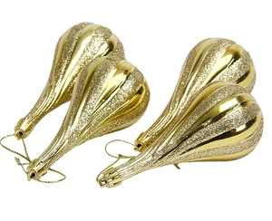 Detail of four golden teardrop Christmas ornaments with glitter and mirror stripe finish