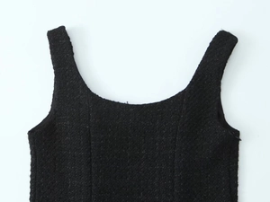 Detail of square neckline on black tweed dress with premium woven fabric texture