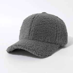 Close-up of deep gray fuzzy sherpa texture and stitching detail on winter baseball cap