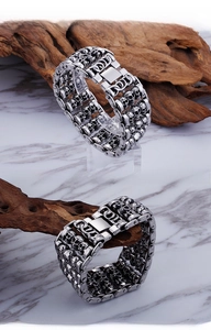 Detail of silver skull link bracelet featuring punk gothic double-row motorcycle chain style