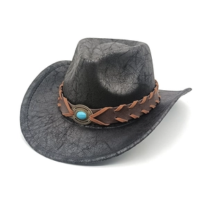Detail of vintage western cowboy hat with cracked texture and turquoise stone belt
