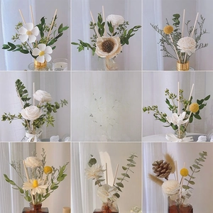 Detailed macro view of assorted dried floral arrangements and wooden diffuser sticks
