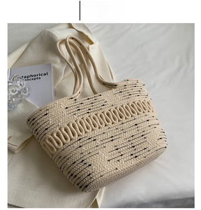 Close-up of the beige woven tote bag featuring black and white polka dots and texture