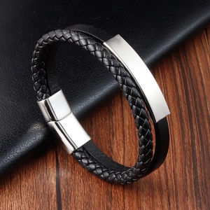 Macro detail of men's double-layer black braided leather bracelet with silver metal plate