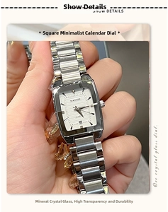 Macro shot of silver square quartz watch with steel band and calendar window detail