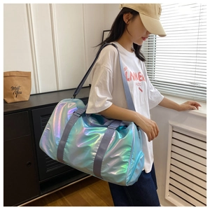 Holographic gradient travel bag with adjustable straps shown on a model for scale