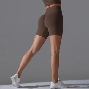 Detail of seamless ribbed high waisted yoga shorts in mocha with push-up effect