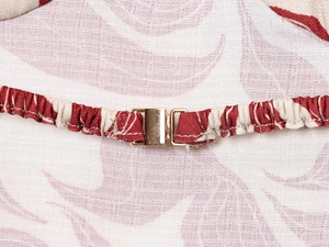 Detail showing the gold metal buckle and elastic pleated floral linen blend fabric