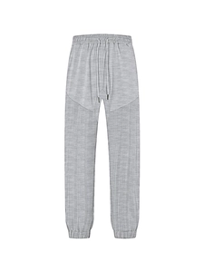 Detail of grey men's joggers showing drawstring waist and textured panel stitching