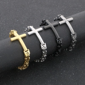 Detail of four Byzantine cross bracelets in gold silver black and gunmetal steel finishes