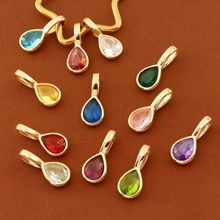 Macro shot of colorful pear-shaped water drop pendants with elegant gold metal edges