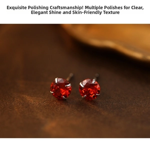 Macro shot of silver stud earrings featuring round red gemstones in a four-prong setting