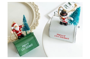 Detailed view of Christmas mailbox ornaments featuring Santa and Snowman figurines