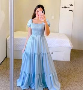 Detail of light blue tiered maxi dress with smocked bodice and puff sleeves on mirror