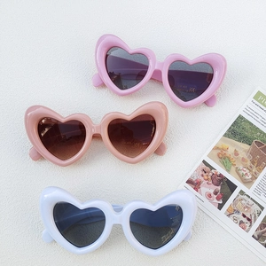 Kids heart-shaped sunglasses in pink and white with UV400 protection on white background