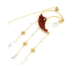 Close-up of golden moon suncatcher with red crystal gravel and faceted glass drops
