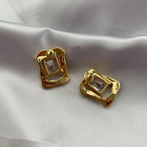 Vintage golden zircon stud earrings with hammered rectangular frame on silk