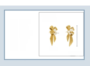Detail view of 18K vacuum plated gold bow earrings with pearls showing 19x41mm size