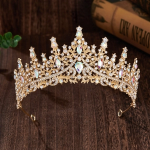 Detail of a luxury gold bridal crown with shimmering crystals and iridescent gems