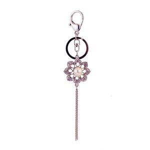 Silver flower keychain with white pearls, clear crystals and metallic tassels for bags