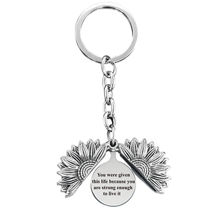 Silver sunflower locket keychain with engraved inspirational quote inside the pendant