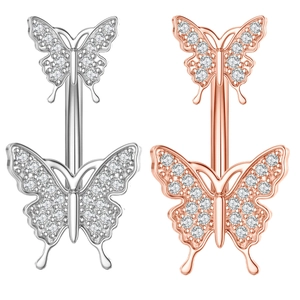 Detailed view of silver and rose gold belly rings with sparkling butterfly zircon crystals