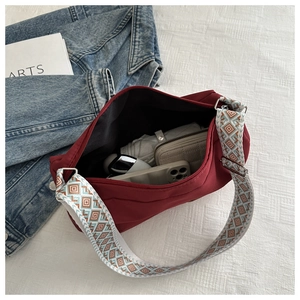 Interior view of burgundy nylon bag showing large capacity for umbrella, wallet and phone
