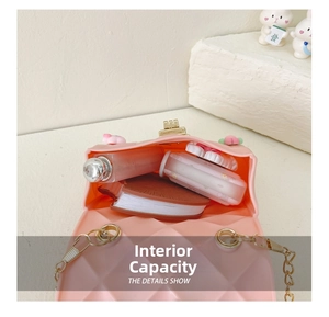Detail view of pink silicone crossbody bag interior holding small daily essentials