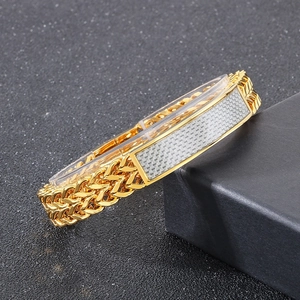 Close-up of gold titanium bracelet with carbon fiber inlay and magnetic clasp detail