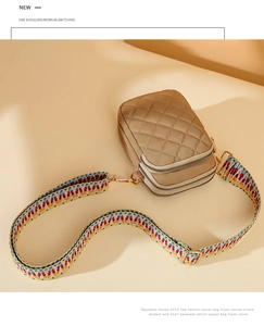 Detail of khaki quilted nylon crossbody bag with stylish colorful woven shoulder strap