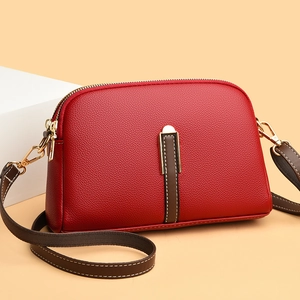 Red lychee pattern leather shell crossbody bag with brown strap and gold hardware accents