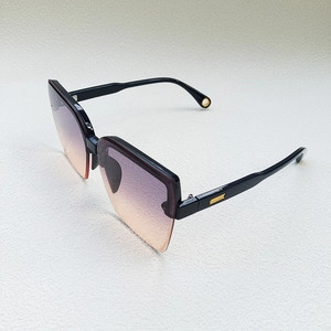 Detailed side view of half-frame sunglasses with purple to orange gradient lenses