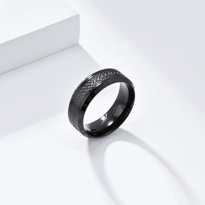 Detailed close-up of vintage black titanium ring featuring Nordic Celtic knot patterns