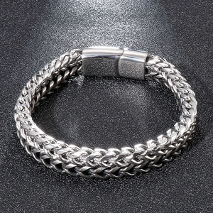 Macro shot of silver stainless steel double woven chain bracelet with square buckle